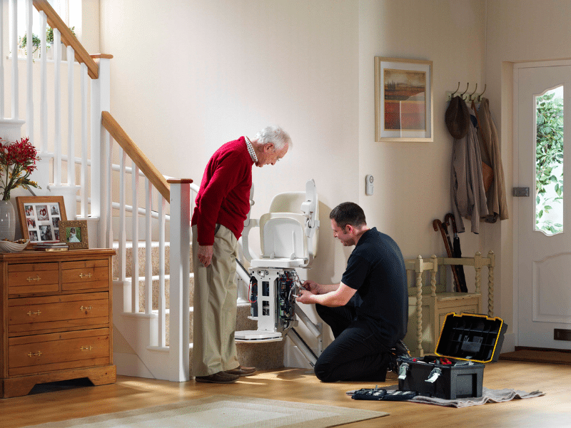 A Pearce Bros Mobility engineer performing a professional stairlift installation for a customer in Bristol